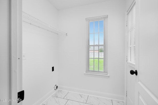 washroom with laundry area, hookup for an electric dryer, baseboards, and marble finish floor