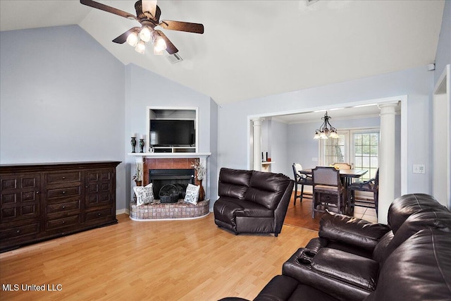 900 Redwood Cv, Byram, MS 39272 - living room with lofted ceiling, a ceiling fan, a fireplace, wood finished floors, and a chandelier