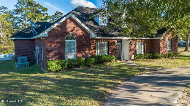 view of front of property featuring a front lawn and cooling unit