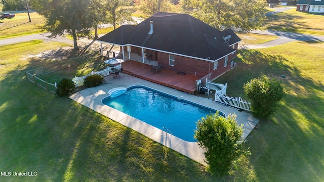 view of swimming pool featuring a patio area and a wooden deck