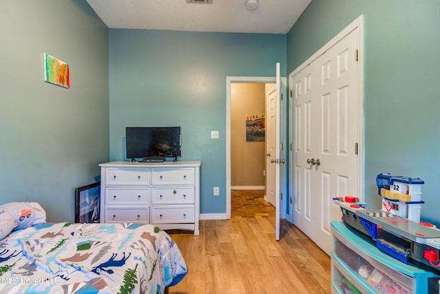 bedroom featuring a closet and light wood-type flooring