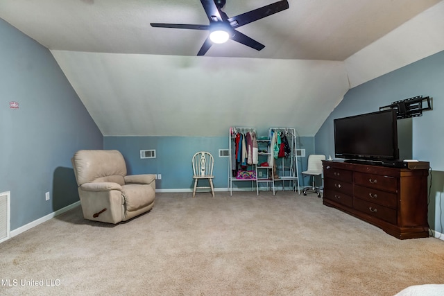 sitting room with ceiling fan, light colored carpet, and vaulted ceiling