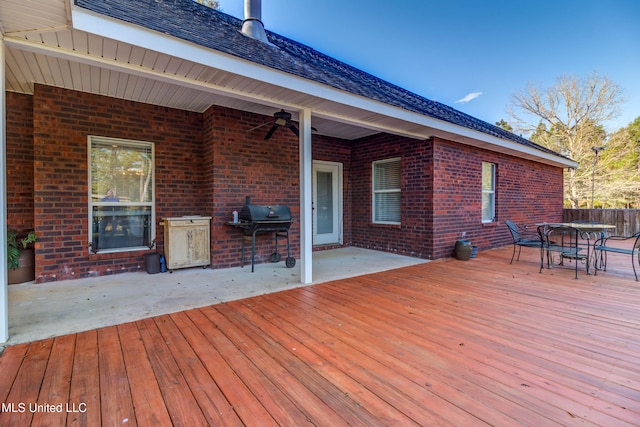 wooden deck featuring a grill