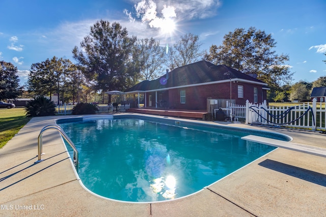 view of pool featuring a diving board and a patio