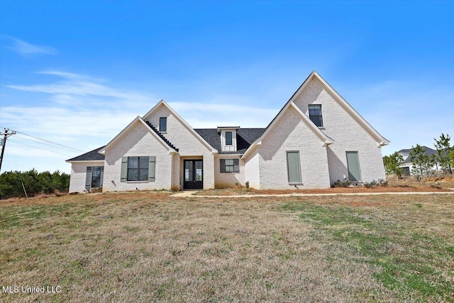 view of front of property with a front yard and brick siding