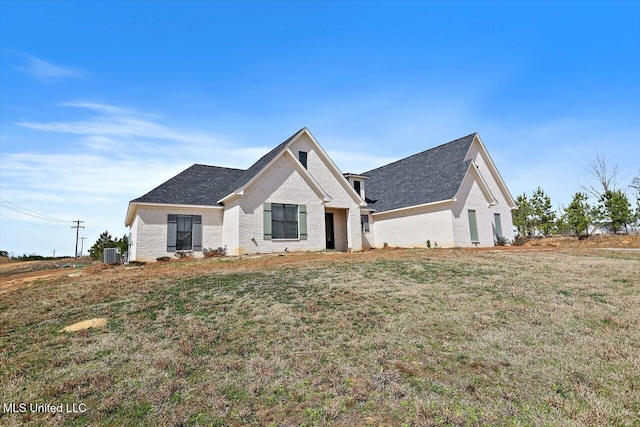 view of front of house featuring a front yard and central air condition unit