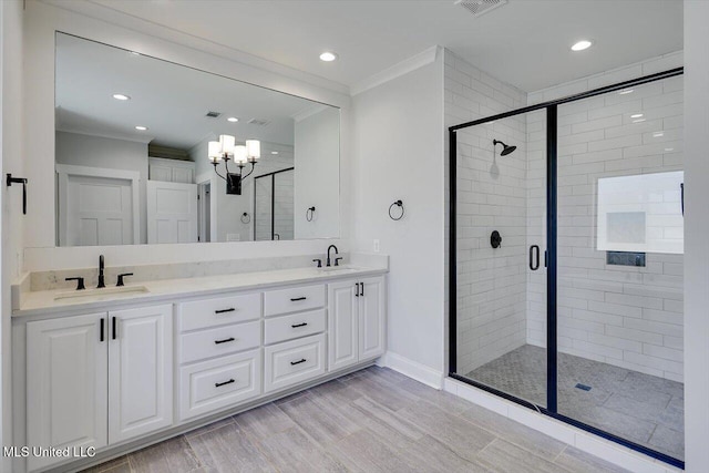 full bath featuring crown molding, a sink, and a shower stall