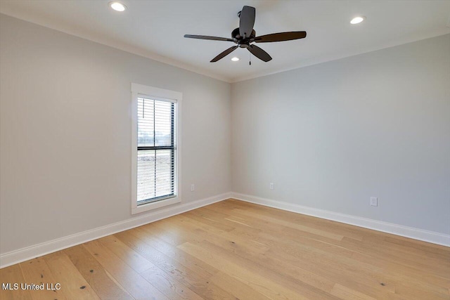 spare room featuring light wood finished floors, baseboards, a ceiling fan, and recessed lighting