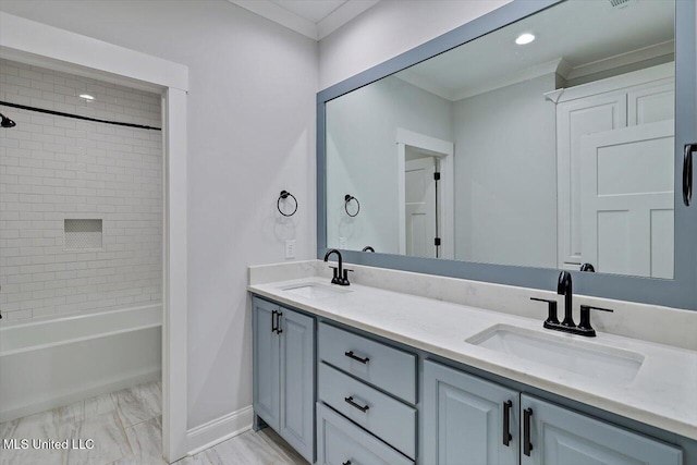 bathroom with baseboards, double vanity, a sink, and crown molding