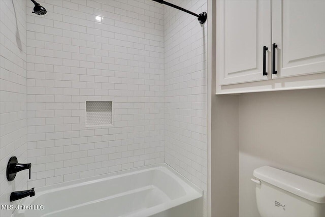 bathroom featuring shower / tub combination and toilet