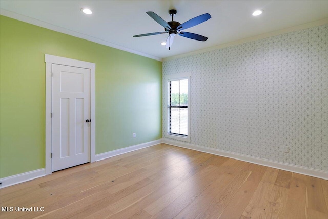 spare room with ornamental molding, baseboards, and wallpapered walls