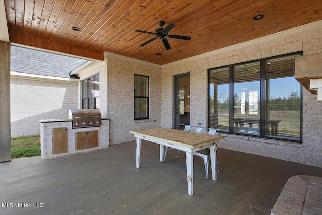 view of patio with a grill, area for grilling, and ceiling fan