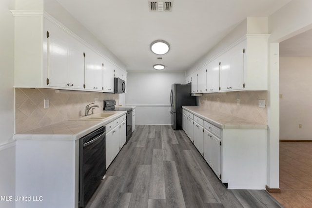 4 Briarwood Cir, Long Beach, MS 39560 - kitchen with black appliances, white cabinets, and tile counters
