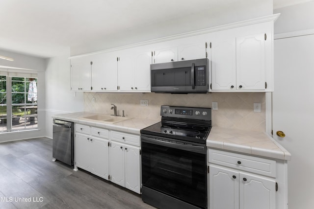 4 Briarwood Cir, Long Beach, MS 39560 - kitchen featuring appliances with stainless steel finishes, tile counters, and white cabinets