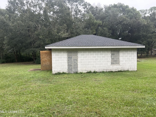 view of outbuilding with a lawn