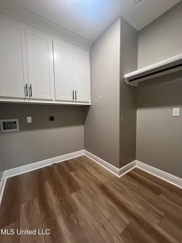 laundry area featuring hookup for a washing machine, cabinets, dark hardwood / wood-style floors, and hookup for an electric dryer