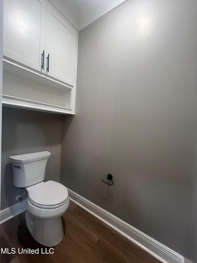 bathroom featuring hardwood / wood-style floors and toilet