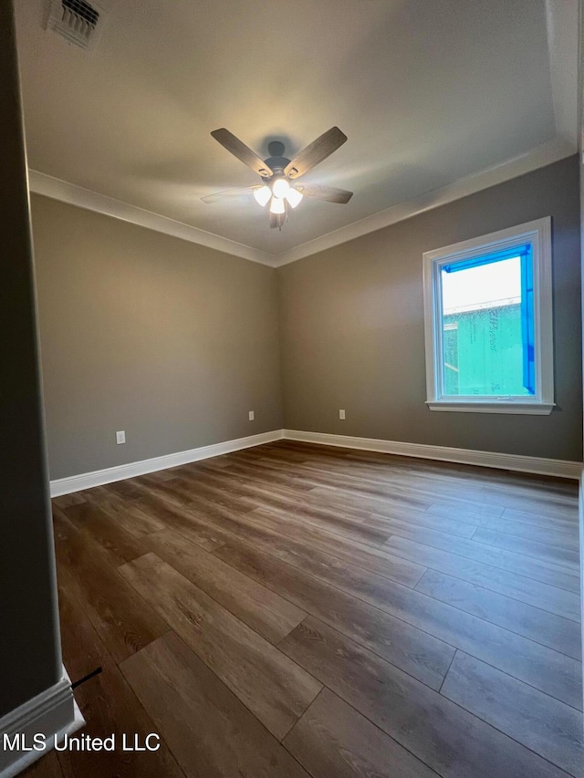 spare room with ceiling fan, dark hardwood / wood-style floors, and ornamental molding