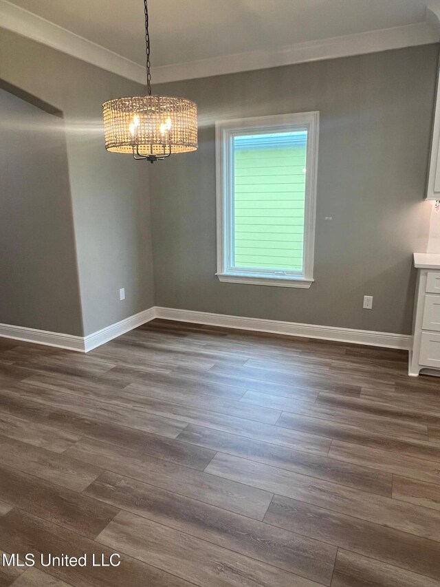 unfurnished dining area with crown molding and dark hardwood / wood-style flooring