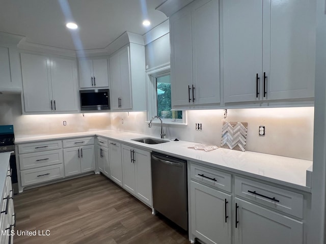 kitchen featuring decorative backsplash, sink, dishwasher, dark hardwood / wood-style floors, and white cabinetry