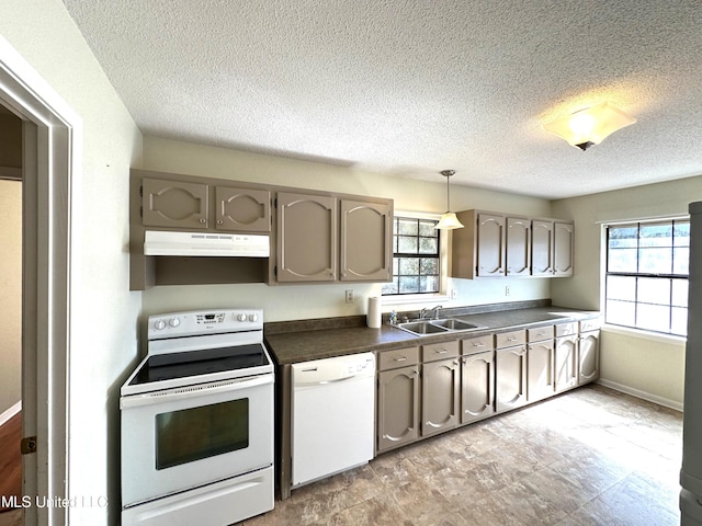 kitchen with white appliances, a textured ceiling, sink, and hanging light fixtures