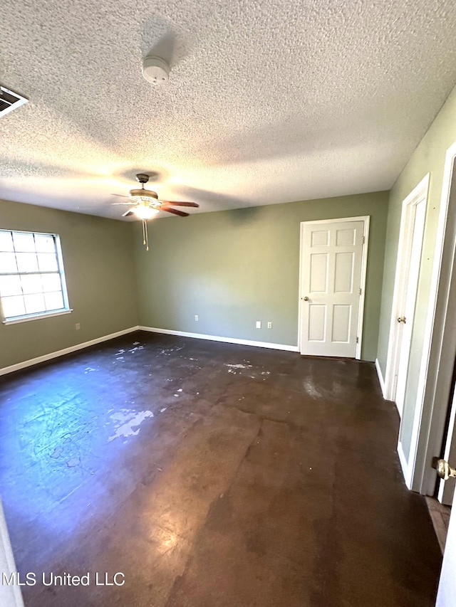 spare room featuring a textured ceiling and ceiling fan