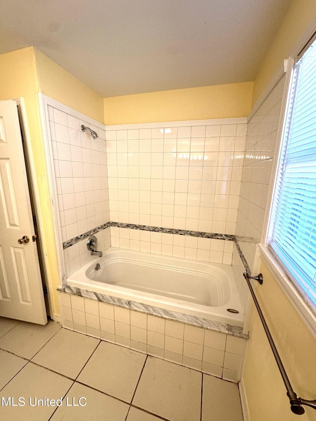 bathroom featuring tiled bath and tile patterned floors