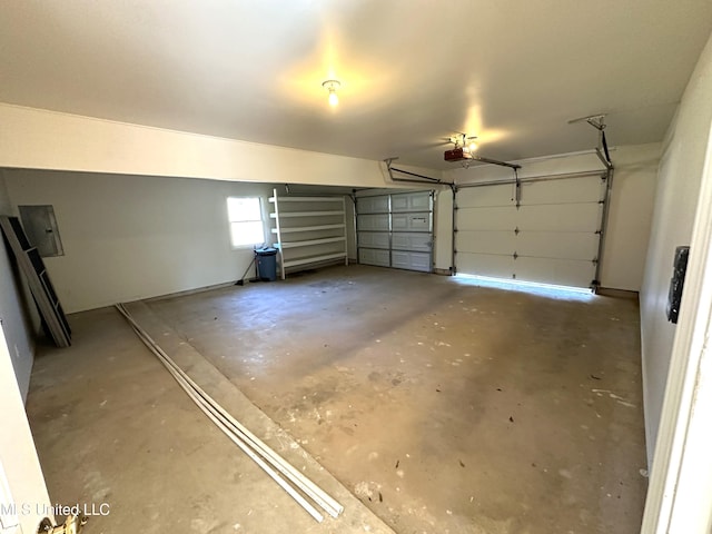 garage with a garage door opener and electric panel