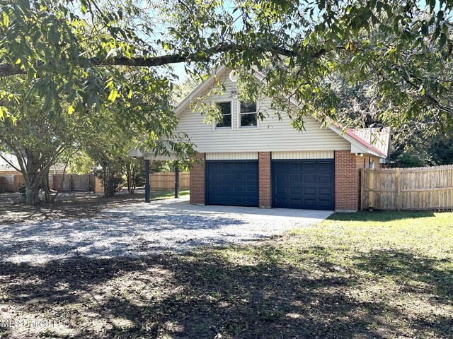 view of side of home featuring a yard and a garage