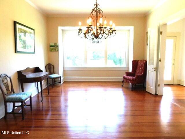 125 Riverside St, Vidalia, LA 71373 - sitting room with crown molding, baseboards, and wood finished floors
