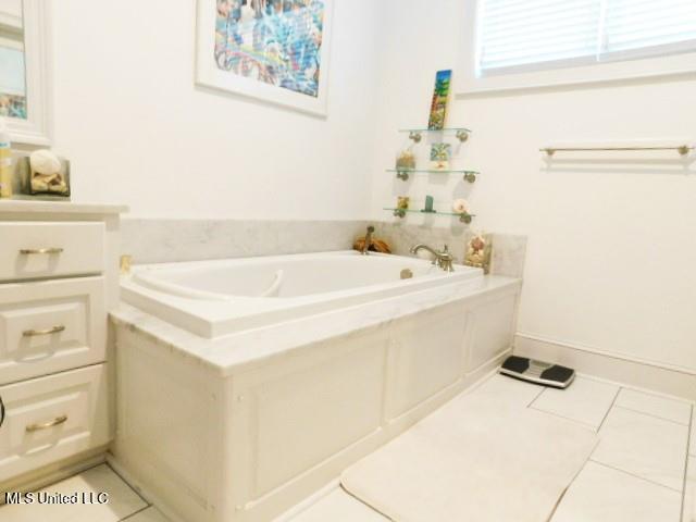 125 Riverside St, Vidalia, LA 71373 - bathroom with a bath and tile patterned floors
