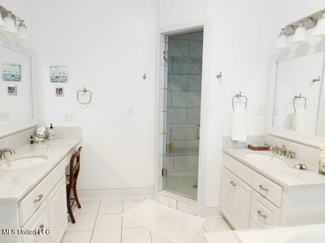125 Riverside St, Vidalia, LA 71373 - full bath featuring tile patterned flooring, a sink, a shower stall, and baseboards