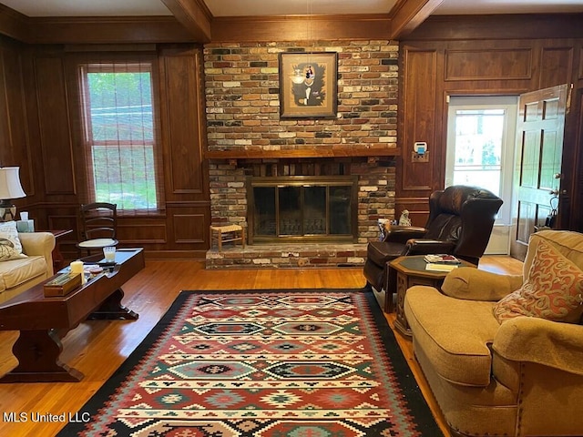 125 Riverside St, Vidalia, LA 71373 - living area featuring a healthy amount of sunlight, beamed ceiling, a fireplace, and wood finished floors