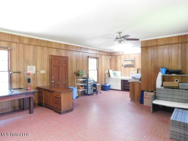 125 Riverside St, Vidalia, LA 71373 - misc room featuring brick floor, ceiling fan, and wood walls