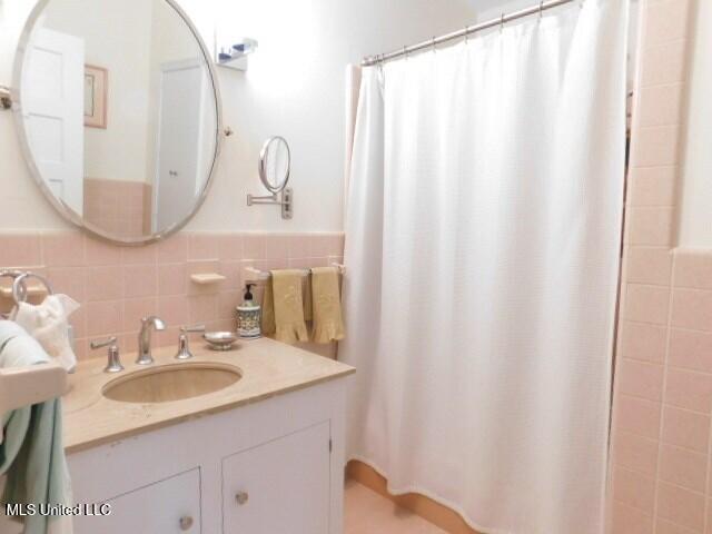 125 Riverside St, Vidalia, LA 71373 - bathroom with curtained shower, tile walls, and vanity