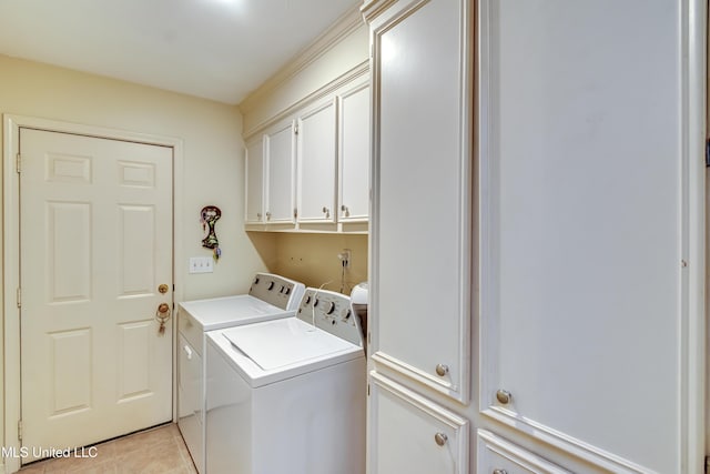 clothes washing area featuring cabinet space, separate washer and dryer, and light tile patterned flooring