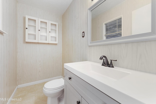 bathroom featuring tile patterned floors, vanity, toilet, and a textured ceiling