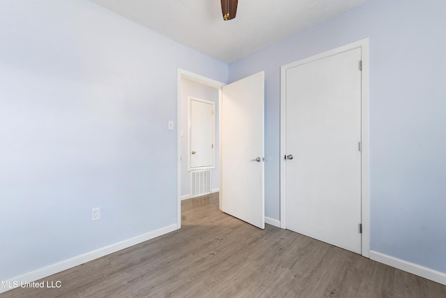 unfurnished bedroom featuring ceiling fan and light hardwood / wood-style floors