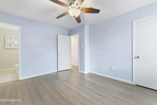 unfurnished bedroom with light wood-type flooring, ceiling fan, and ensuite bathroom