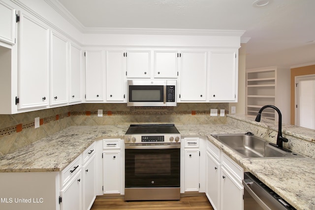 kitchen featuring crown molding, white cabinetry, sink, and appliances with stainless steel finishes