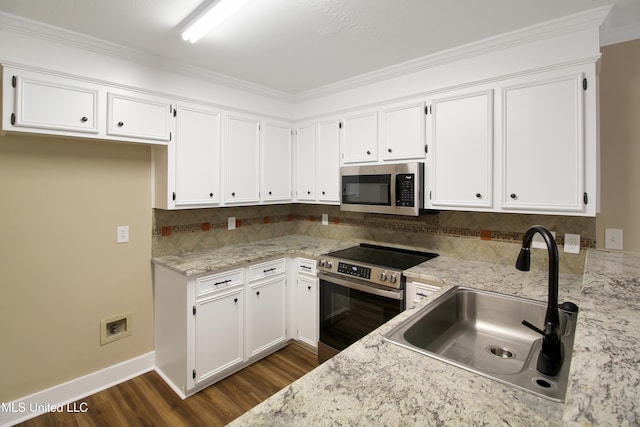 kitchen with white cabinets, stainless steel appliances, tasteful backsplash, and sink