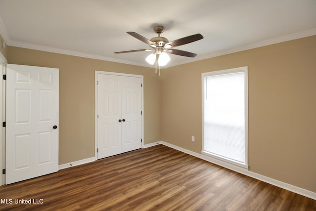 unfurnished bedroom with hardwood / wood-style floors, ceiling fan, crown molding, and a closet