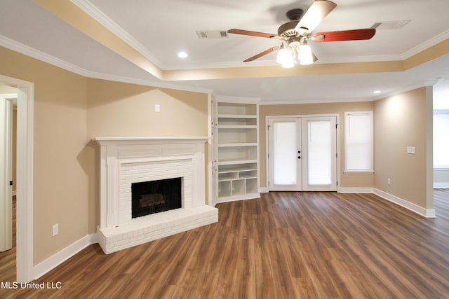 unfurnished living room with a brick fireplace, ceiling fan, french doors, and ornamental molding