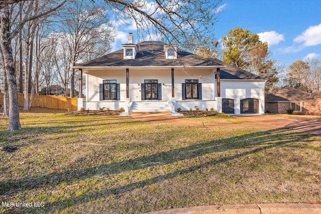 view of front of property with a chimney, a front lawn, and fence