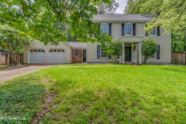 colonial inspired home with a front yard and a garage