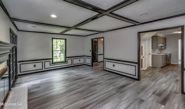 unfurnished living room featuring coffered ceiling, crown molding, and light wood-type flooring