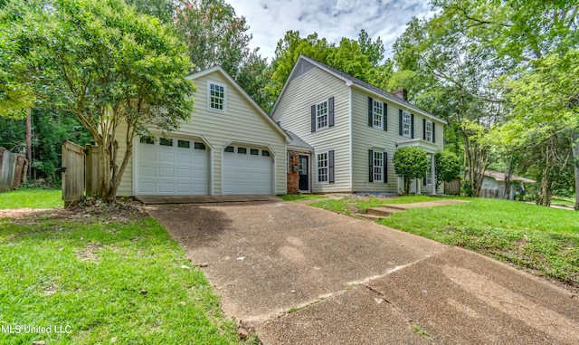 view of front of property with a front lawn and a garage