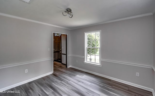 unfurnished room with ornamental molding and wood-type flooring