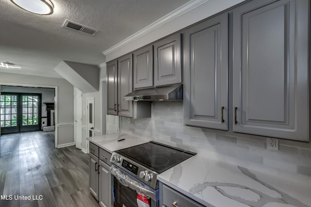 kitchen featuring light stone countertops, electric range, and gray cabinetry