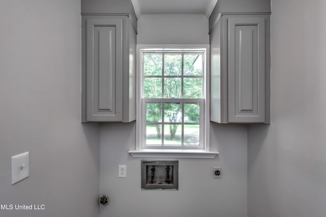 clothes washing area featuring cabinets, hookup for an electric dryer, and washer hookup